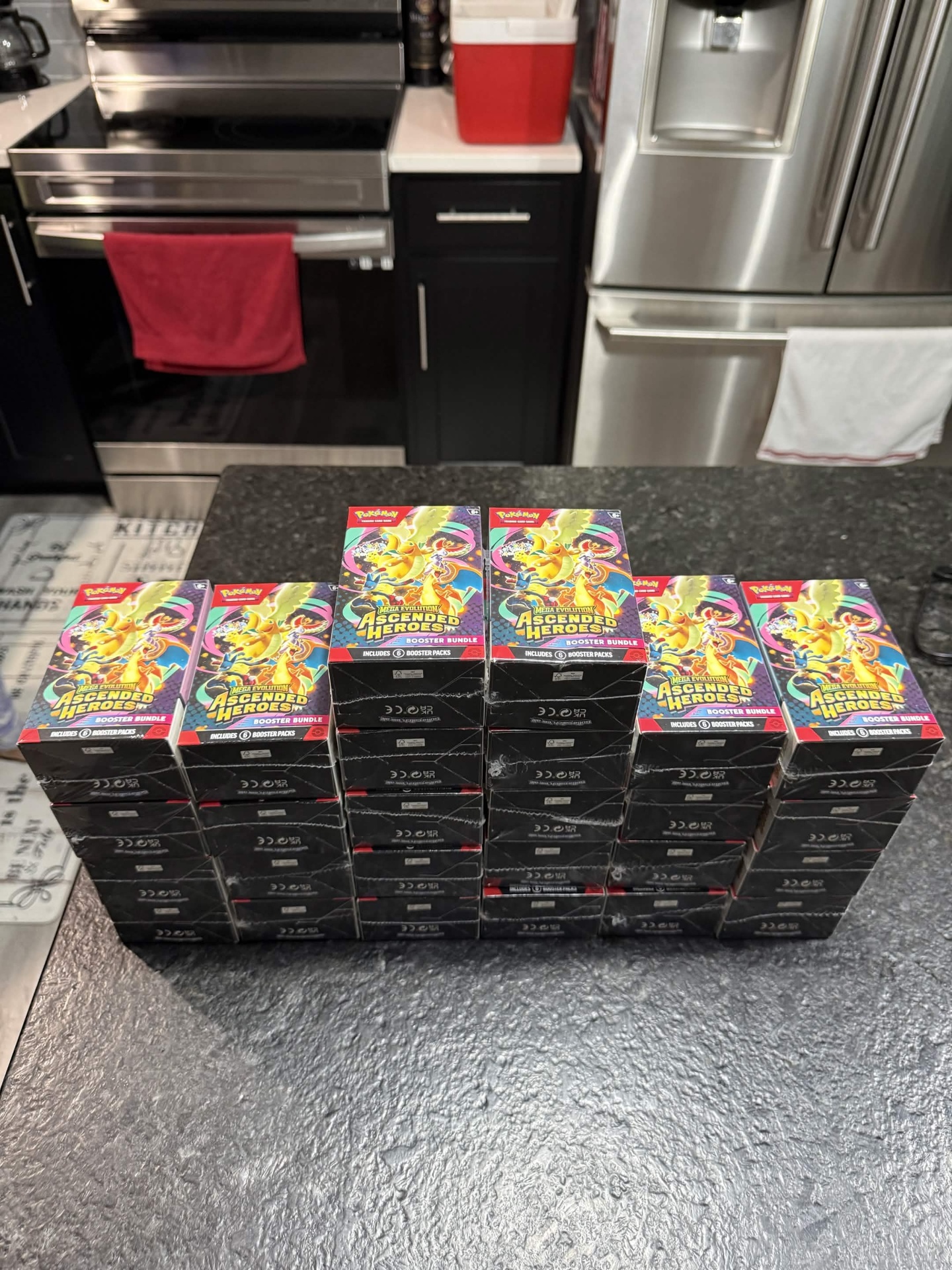Rows of Mega Evolution Ascended Heroes Booster Bundles stacked on a counter